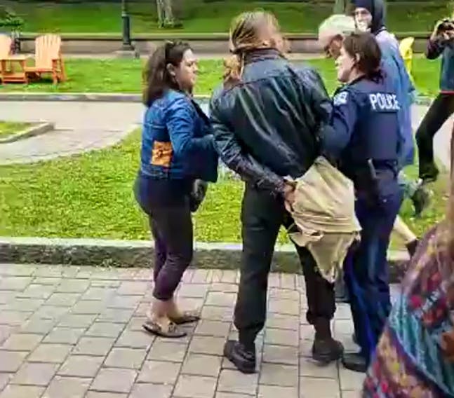 Halifax Regional Police say members of the National Citizens Alliance were assaulted by protesters at Grand Parade in Halifax on Saturday. Shown is a screen shot of a video showing a protester being arrested. National Citizens Alliance Facebook