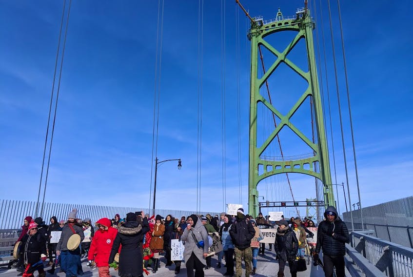 About 100 protesters marched across the Macdonald Bridge in Halifax on Saturday to highlight issues affecting First Nations people. - JOHN McPHEE