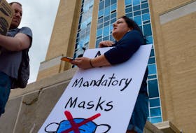 Amanda Green stands in front of Confederation Building Thursday afternoon as she protests a mandatory mask order issued by Chief Medical Officer of Health Dr. Janice Fitzgerald.

Keith Gosse/The Telegram