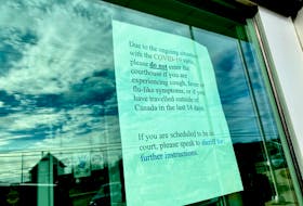 A message on the door of the Yarmouth Justice Centre telling people that if they're traveled outside of the country recently they are not allowed inside the courtroom. TINA COMEAU PHOTO