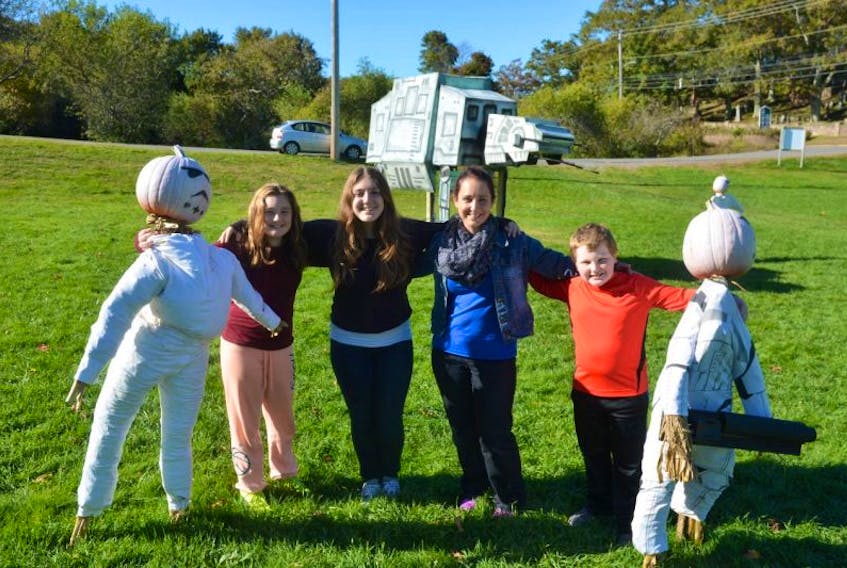 11-year-old Lexie, 15-year-old Faith, mom Kelly and 10-year-old Seth Cormier of Fredericton enjoy the sunshine and the Star Wars pumpkin people display at Kentville’s Burgher Hill on Oct. 10.