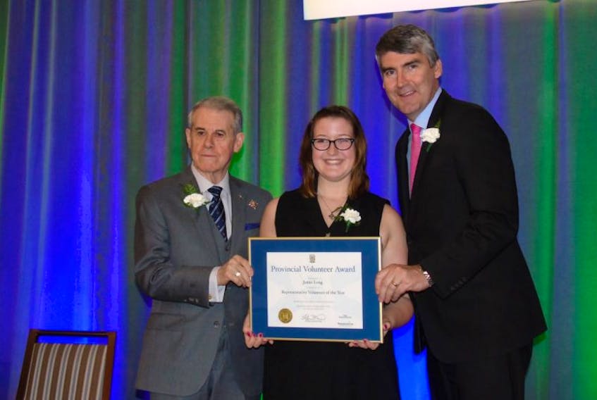 Jamie Long, centre, receives a Volunteer of the Award at an event to recognize Nova Scotia volunteers in Halifax recently. Presenting the award is Lieutenant Governor J.J. Grant, left, and Premier Stephen MacNeill.