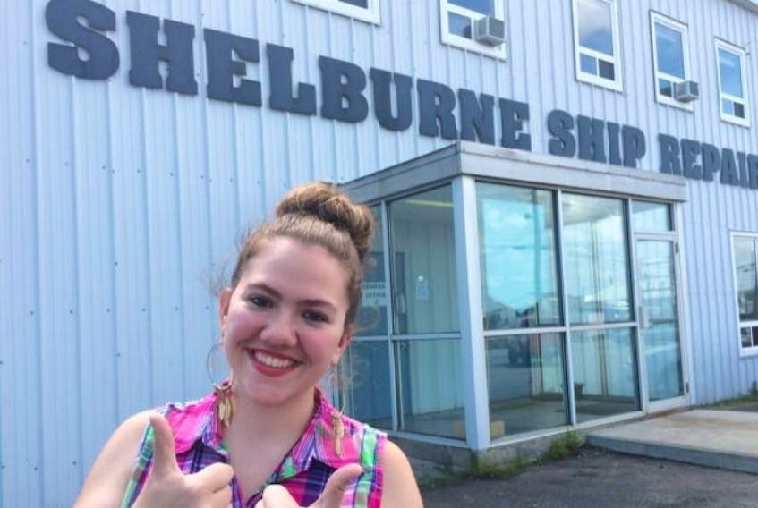 Victoria Henneberry poses in front Irving’s Shelburne Ship Repair, her preferred employer.