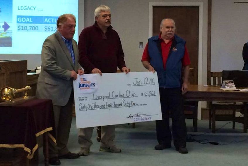 Mayor Christopher Clarke, John Armstrong, president of the Liverpool Curling Club, and Greg Thorbourne, chairman of the 2014 Host Committee, pose for a photo with the $61,861 oversized cheque.