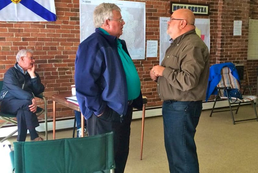 Queens-Shelburne Liberal candidate Vernon Oickle, right, chats with his campaign chair, Raymond Fiske, as they wait for the polls to close. It’s a tight race in the district, with many suggesting the election here is too close to call.
