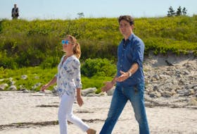 Prime Minister Justin Trudeau and his wife, Sophie Gregoire Trudeau, stroll along the beach at Kejimkujik National Park Seaside in Port Joli.