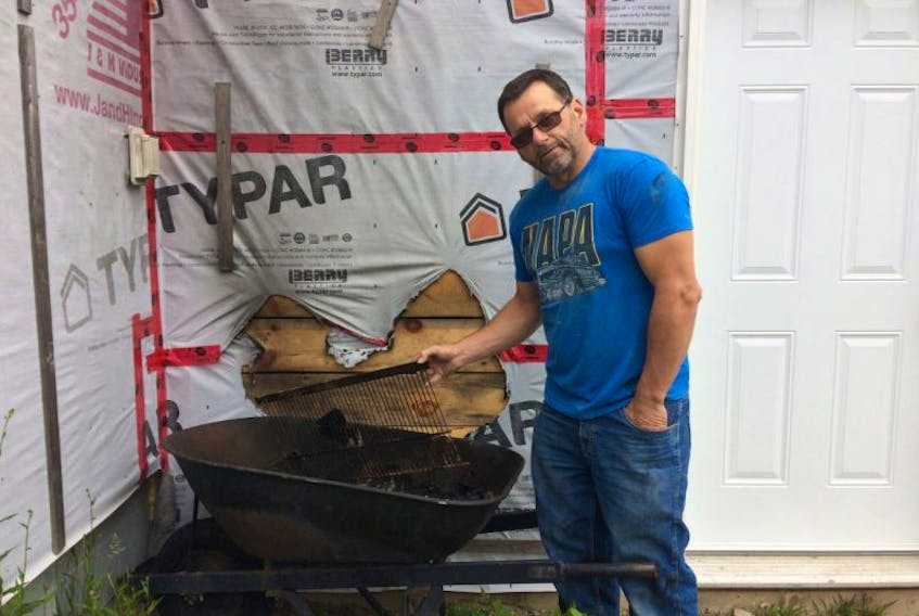 Steven Daury, owner of Daury’s Paint & Collision, was shocked to find a wheelbarrow filled with blackened shingles and tar paper beside his garage.