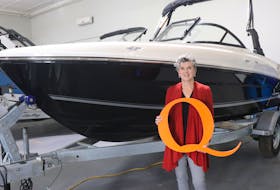 QEH Foundation board chairwoman Patsy MacLean stands with a Bayliner VR4 Outboard boat and trailer at Quartermaster Marine. This boat is the top prize for the QEH Foundation's Mask-Q-rade Elimination Draw & Auction.  Contributed.