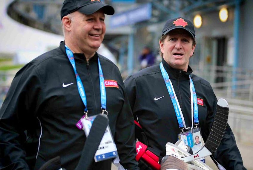 Team Canada coaches Claude Julien, left, and Mike Babcock make their  way to the hockey practice facility at the 2014 Olympic Winter Games in Sochi, Russia, on  February 18, 2014. Al Charest/Postmedia