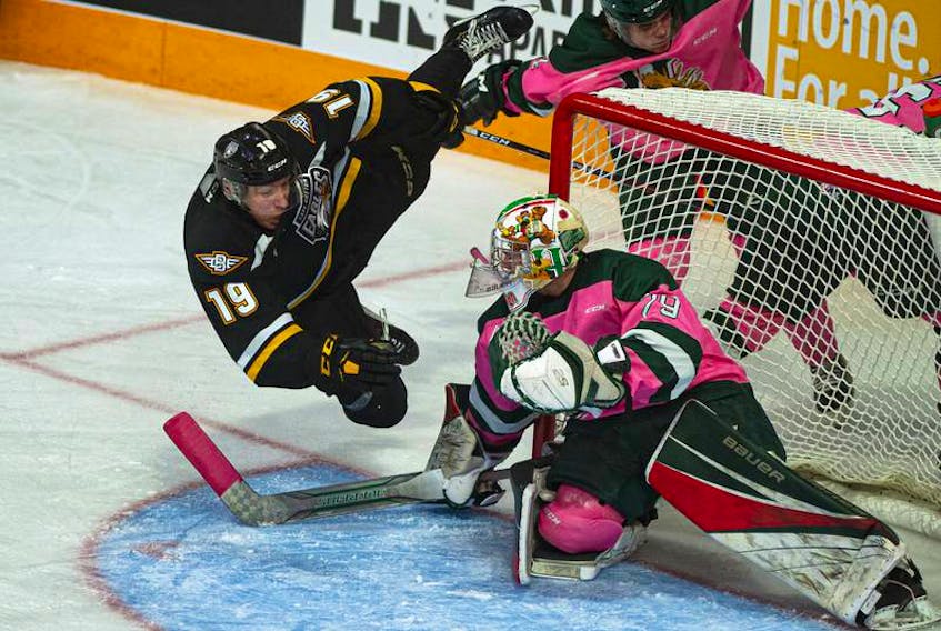 Cape Breton Eagles forward Shaun Miller flies through the air beside Halifax Mooseheads goalie Cole McLaren during an Oct. 20, 2019 QMJHL game at the Scotiabank Centre. (FILE) 