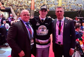 Centre Justin Gill was the Charlottetown Islanders’ second pick of the 2019 Quebec Major Junior Hockey League draft in Quebec City. He was welcomed to the franchise by head coach and general manager Jim Hulton, right, and associate coach and assistant general manager Guy Girouard.
