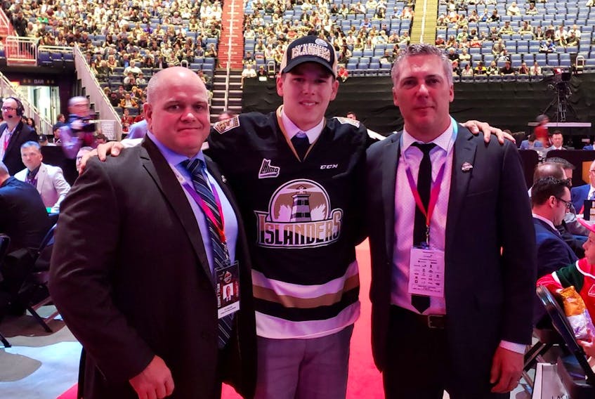 Centre Justin Gill was the Charlottetown Islanders’ second pick of the 2019 Quebec Major Junior Hockey League draft in Quebec City. He was welcomed to the franchise by head coach and general manager Jim Hulton, right, and associate coach and assistant general manager Guy Girouard.
