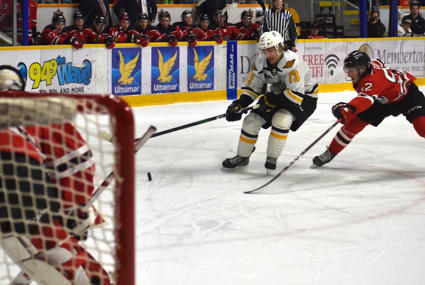 Cape Breton Eagles forward Félix Lafrance, middle, works his way to the net as he’s pressured by Anthony Gagnon of the Quebec Remparts during Quebec Major Junior Hockey League action at Centre 200 in Sydney on March 4. The QMJHL is targeting an Oct. 1 start date for the 2020-21 season, depending on the COVID-19 situation. JEREMY FRASER/CAPE BRETON POST