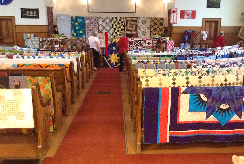 Visitors to a previous Sackville Quilters Guild’s show check out the large variety of quilts on display.