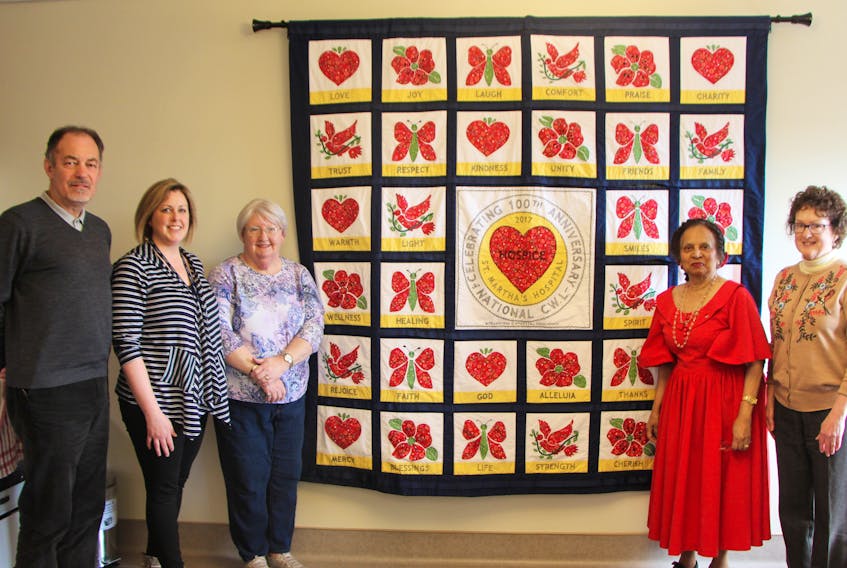 Coming together for a photo around the Quilt of Life, presented to the palliative care unit at St. Martha’s Regional Hospital by the St. Ninian’s CWL council April 4, were Dr. Phillip Cooper, manager of cancer care and palliative care Andrea MacDonald, Antigonish Town and County Palliative Care Society member Pauline Liengme, council president Yvette deSouza-Muise and member Catherine MacNeil-MacDonald.