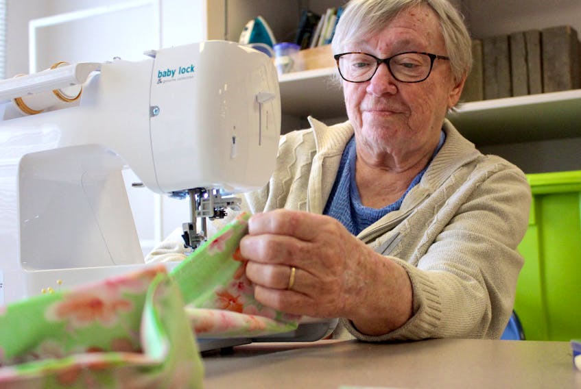 Sharon Ormond examines the stitching on a pillowcase she was working on Monday at the Cape Breton Centre for Craft and Design in downtown Sydney. The Mira Road resident is a member of the Breton Quilters Guild, which meets every week at the centre on Charlotte Street from 10 a.m.-3 p.m. New members are always welcome. Chris Connors/Cape Breton Post

