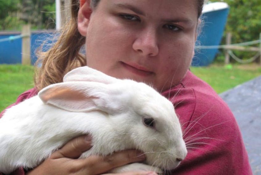 In this file photo Leah Reagh of Kentville holds one of her rabbits at Hennigar’s Farm Market petting zoo. 