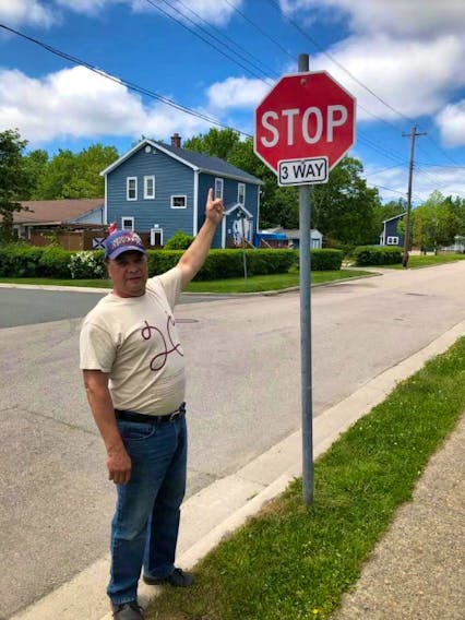 Danny J. Paul points to a street sign in the Ashby neighbourhood of Sydney that did bear the Cornwallis Street sign. A Cape Breton Regional Municipality public works crew removed all nine street signs bearing the 18th-century British general's name on Monday. KAREN RUSHTON-PAUL/FACEBOOK