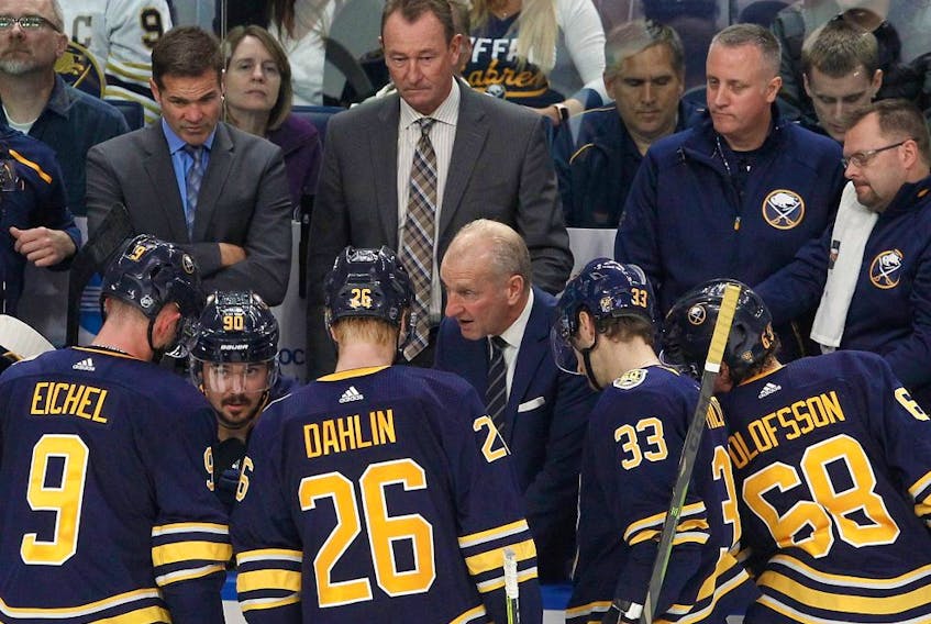 Sabres head coach Ralph Krueger (centre) discusses power play options with Jack Eichel (9), Rasmus Dahlin (26), Colin Miller (33), and Victor Olofsson (68), late in the third period at KeyBank Center in Buffalo, N.Y., on Oct. 9, 2019.
