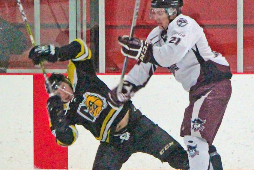 Randon MacKinnon (right), a fourth-year forward with the Strait Pirates, dishes out a body check during a 7-1 victory over the Antigonish Farmers’ Mutual Junior Bulldogs. Corey LeBlanc