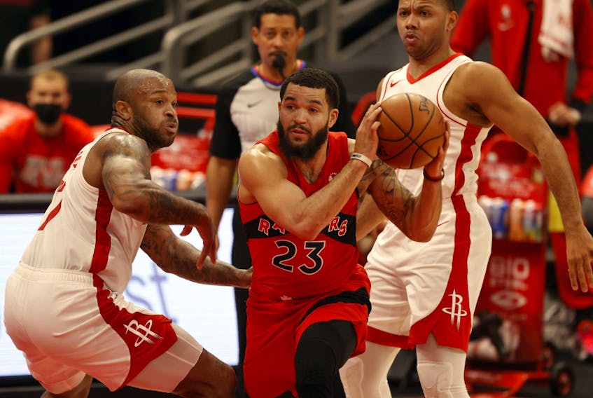 Toronto Raptors guard Fred VanVleet, centre, drives to the basket as Houston Rockets guard Eric Gordon and forward P.J. Tucker defend during the first half at Amalie Arena in Tampa, Fla., Feb. 26, 2021.