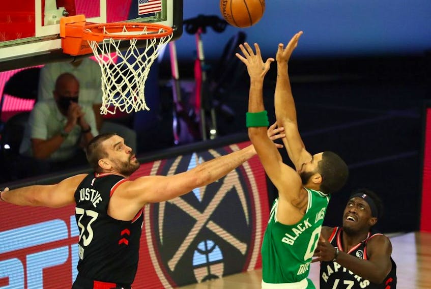 Boston Celtics forward Jayson Tatum (0) shoots against Toronto Raptors centre Marc Gasol (33) and forward Pascal Siakam (43) Wednesday at ESPN Wide World of Sports Complex.