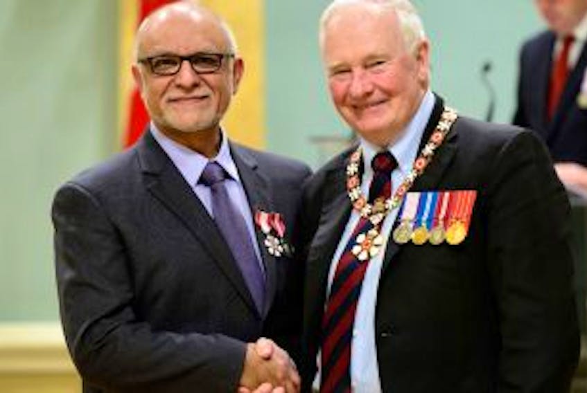 ['<p>Dr. Mohamed Ravalia (left) received the Order of Canada from the Governor General David Johnston.</p>']