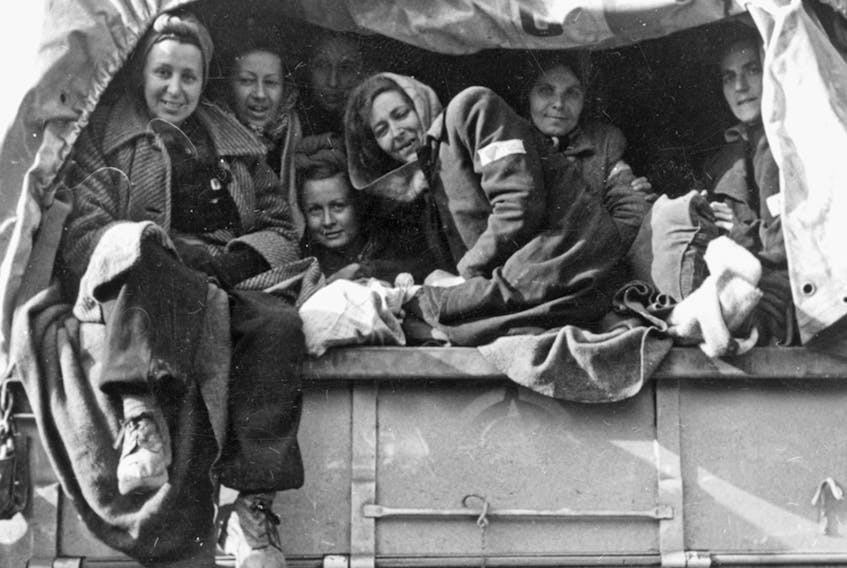 Women released from the Ravensbruck concentration camp arrive in Switzerland on a ICRC truck.