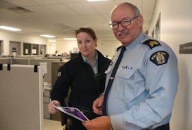 Constable Lori Thorne and Staff Sergeant Allan Carroll, of the Colchester District RCMP, are two of the officers trying to protect people against scammers by sharing printed information such as ‘The Little Black Book of Scams.’ March is fraud prevention month. LYNN CURWIN/TRURO NEWS