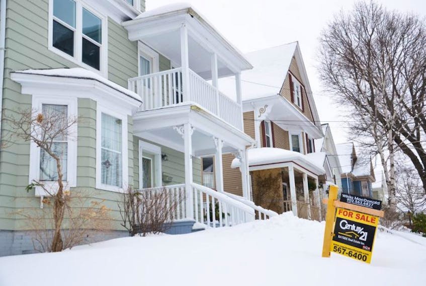A for sale sign sits on the snow covered front yard of this home on Beacon Street in Sydney. Home sales across the island were strong last year and to start this year in Cape Breton. That trend is expected to continue right across the province for the rest of 2015.<br /><br /><br />