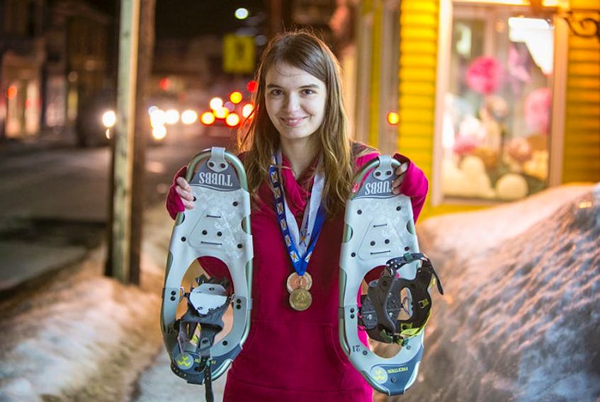 Rebecca Delaney holds up her snowshoes and wears her medals proudly. The 18-year-old recently competed and had a great showing a the Special Olympics in Kentville.