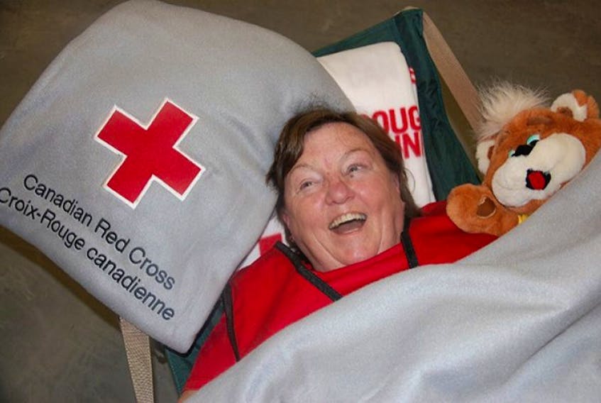 <span>Red Cross volunteer Jan Barnes of St. Peters Bay gets wrapped up in some of the supplies stored in the new home of the Canadian Red Cross in P.E.I. Friday marked the grand opening of a building that houses the new Red Cross Disaster Management and Training Centre.</span>