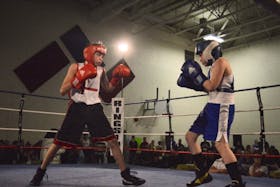 Cruz Sylliboy, left, of Red Tribe Boxing Club is shown fighting Braydon Collins of North Sydney during the Red Tribe Boxing Club’s first-ever Saturday Fight Night at the Eskasoni Elementary/Middle School in Eskasoni on Saturday. Collins won the fight by decision. 