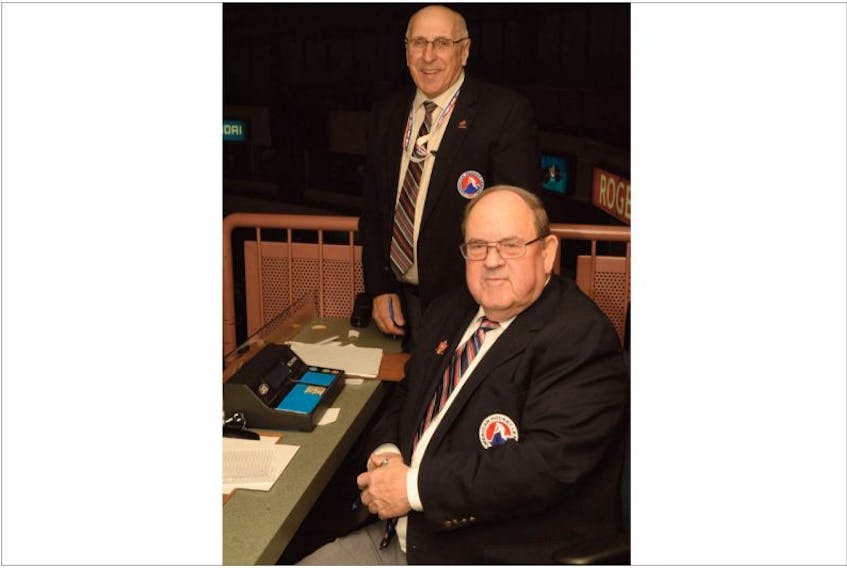 Off-ice officials Reg White (back) and Don Walsh have been tabulating shots and monitoring players’ shifts at AHL games since the early 1990s.
   