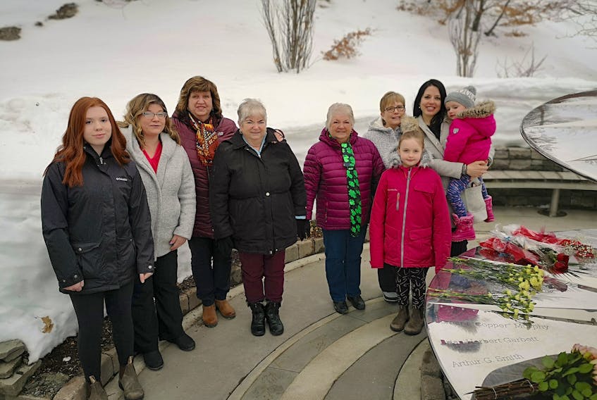 The families of Bernard (Copper) Murphy and Capt. Gary Freeman Fowlow, who both died in the Universal Helicopter crash of 1985, at the memorial in St. John's on Thursday. From left are Summer Woodfine, Erin Murphy-Woodfine, Marilyn Lythgoe, Kathy Murphy, Cynthia Murphy-Downey, Hilda Buckles, and Melissa Fowlow and her two children, Ella Whiteway (standing) and Mara Whiteway. Andrew Waterman/The Telegram 