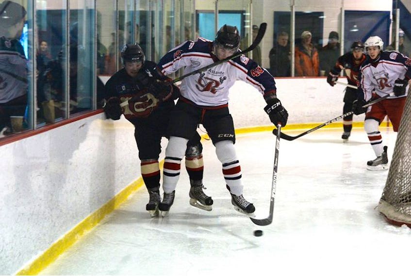 The St. John’s Caps’ Joey Trenholm (left) high sticks the CBR Renegades’ Zack Hoskins during the teams’ game Saturday night at Twin Rinks. The Renegades went on to win 3-1.