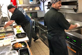 Brendon MacKinnon, left, and Robin Rocky were among staff members preparing take out orders at Governor’s on Thursday. It was the first day the restaurant had been opened since COVID-19 precautions were put into place. Dine-in service will be available on June 5. GREG MCNEIL/CAPE BRETON POST