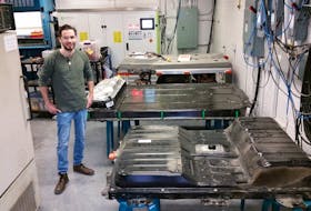 Dalhousie engineering PhD candidate Chris White, shown in the Renewable Energy Storage lab at Dal, is working on a way to incorporate used electric vehicle batteries into power grid systems as a means to possibly supplement a future based on renewable energy.