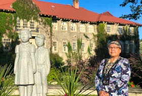 Margaret Teneese, archivist of the Ktunaxa Nation Council, stands in front of the former residential school which has been transformed into St. Eugene Golf Resort &amp; Casino near Cranbrook, B.C. 