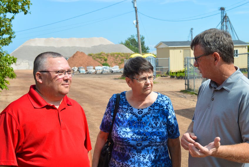 Charlottetown Ward 2 Coun. Terry MacLeod, right, talks to area residents Kevin Clory and Anna Hardy over their frustration with trucks carrying gravel from the pit in the background, not abiding by approved truck routes and the dust all of it is creating.