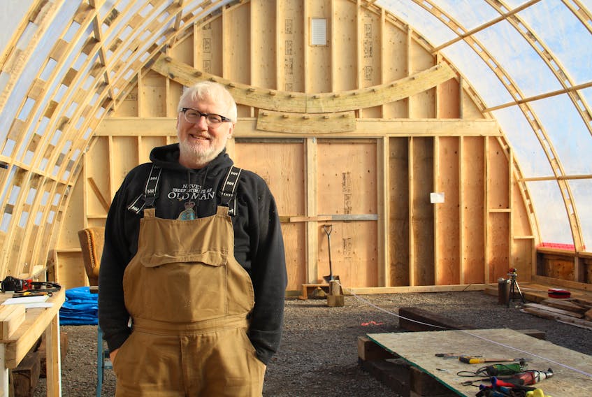 Bill England standing proudly in his boat shed. It’s been a work in progress since the Spring, and he’s finally ready to start constructing the boat itself.