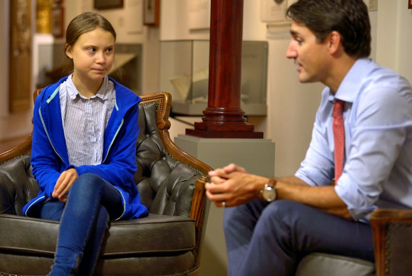 Canada's Prime Minister Justin Trudeau greets Swedish climate change teen activist Greta Thunberg on September 27, 2019.  
