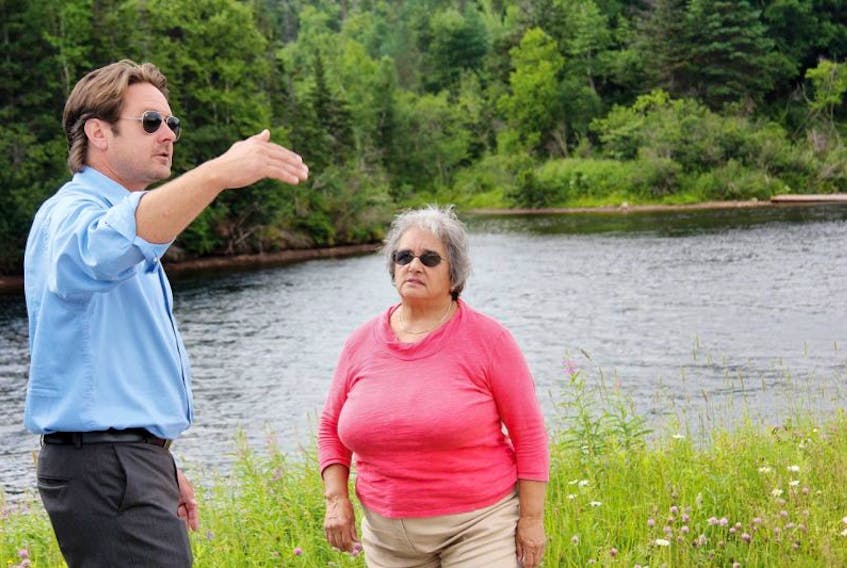 Deer Lake resident Richard Dewey speaks with NDP Leader Lorraine Michael about the alleged seeping of water from Deer Lake canal that is flooding area properties and homes.