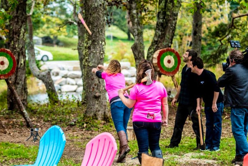 <p>Getting axe-throwing lessons from some of the Wild Axe Women, Suzy Atwood and Sam Brannen.</p>