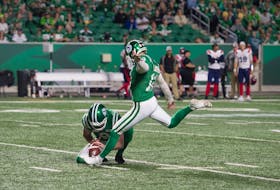 Jon Ryan pins the ball for placekicker Brett Lauther on the Saskatchewan Roughriders' game-winning field goal against the Montreal Alouettes on Saturday.
