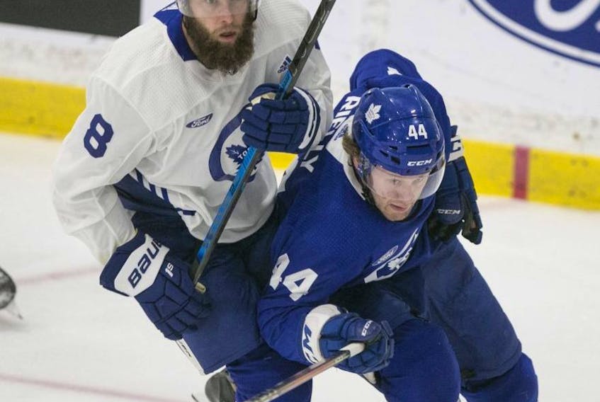 Leafs GM Kyle Dubas had high praise for defenceman Morgan Rielly (right). “On any team, you need a guy who will always put the team ahead of themselves,” he said. Toronto Sun file