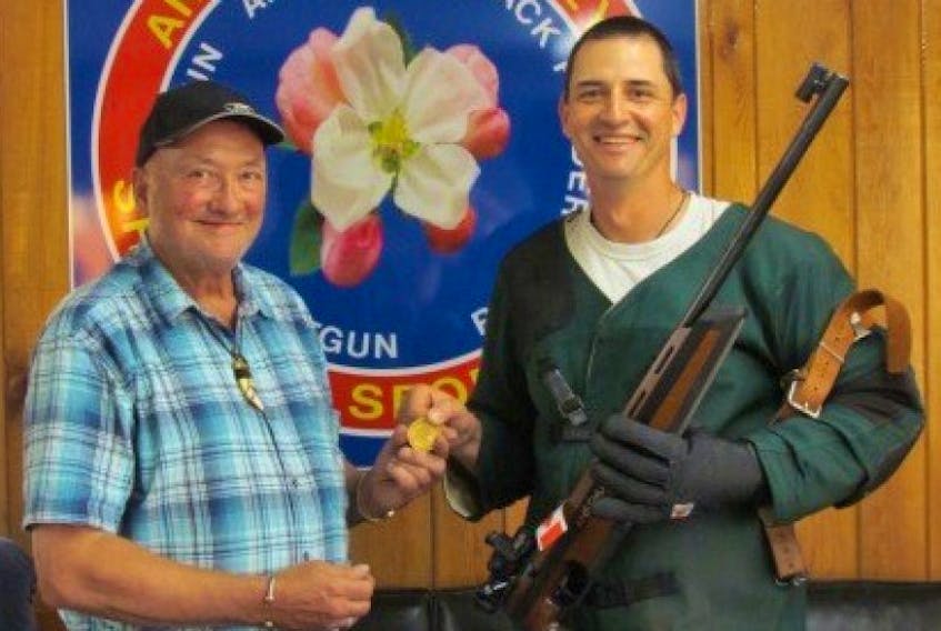 <p>Marcel Kolb of New Minas and the Annapolis Valley Shooting Sports Club receives his national gold medal, won at a recent Dominion of Canada Rifle Association competition, from AVSSC rifle chair Paul Comeau. - Submitted</p>