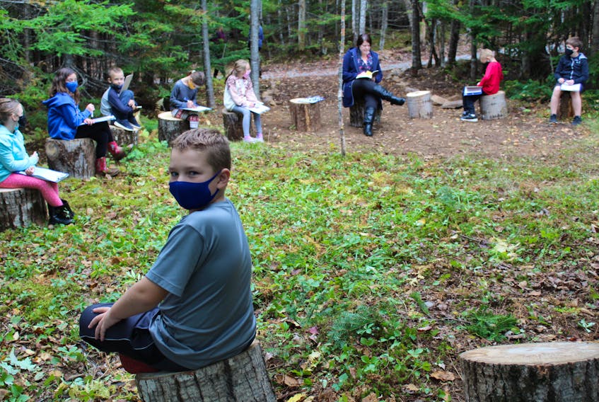 Eight-year-old Kayden Duchene from Louisbourg and the rest of his Riverside School classmates complete an afternoon lesson in the Sharing Circle, one of the outdoor learning spaces along the Knowledge Path at the Albert Bridge school. NICOLE SULLIVAN • CAPE BRETON POST 