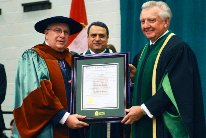 <span class="BodyText"> UPEI chancellor Don McDougall, right, and president Alaa S. Abd-El-Aziz present Moncton businessman Robert K. Irving with an honorary degree during UPEI's convocation. Irving is co-chief executive officer of J.D. Irving Limited.<br /></span>