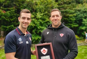 Patrick Parfrey (left) was presented with the Canadian Shield Award as Rugby Canada’s senior player of the year recently by national senior men’s team assistant coach Jamie Cudmore. — Submitted photo